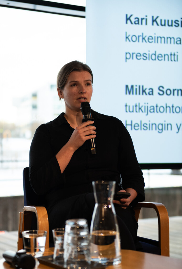 Milka Sormunen puhumassa mikrofoniin.